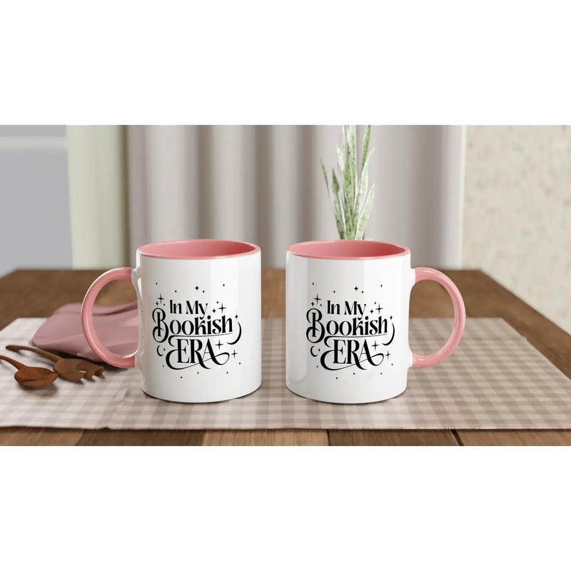 In My Bookish Era white ceramic mugs with pink inside on a table, perfect for coffee or hot drinks.