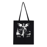 Black tote bag featuring fantasy art with a dragon, castle, and books, perfect for eco-conscious on-the-go use.